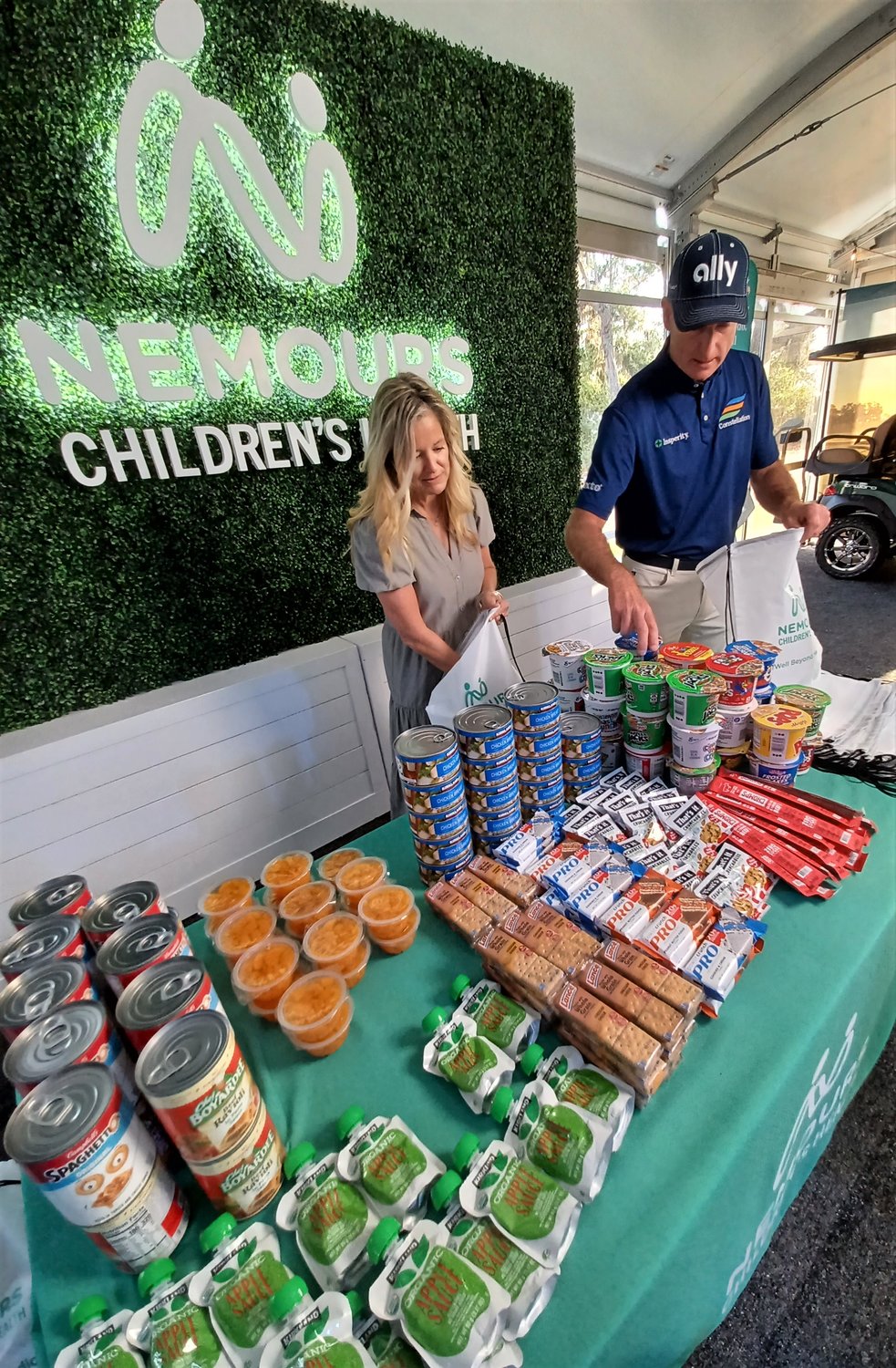 Tabitha and Jim Furyk pack food bags for area children facing food insecurity.